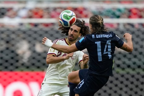 Marc Cucurella heads the ball away from Agustin Canobbio.