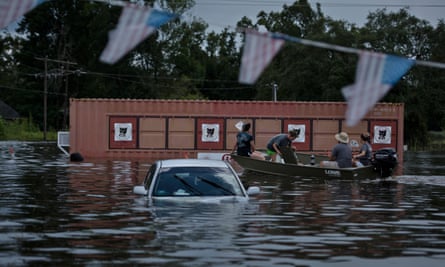 A car is seen after flooding in Gonzales, Louisiana. Extreme weather events are one factor in more climate cases being filed.