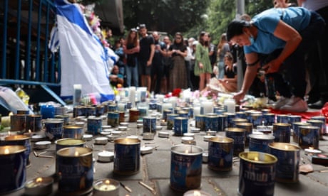 Mourners light candles for victims of the attack in Dizengoff Street in central Tel Aviv