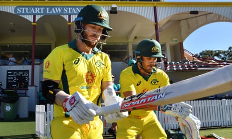 David Warner (left) walks out to bat with captain Aaron Finch for an Australia XI practice match against New Zealand earlier this month.