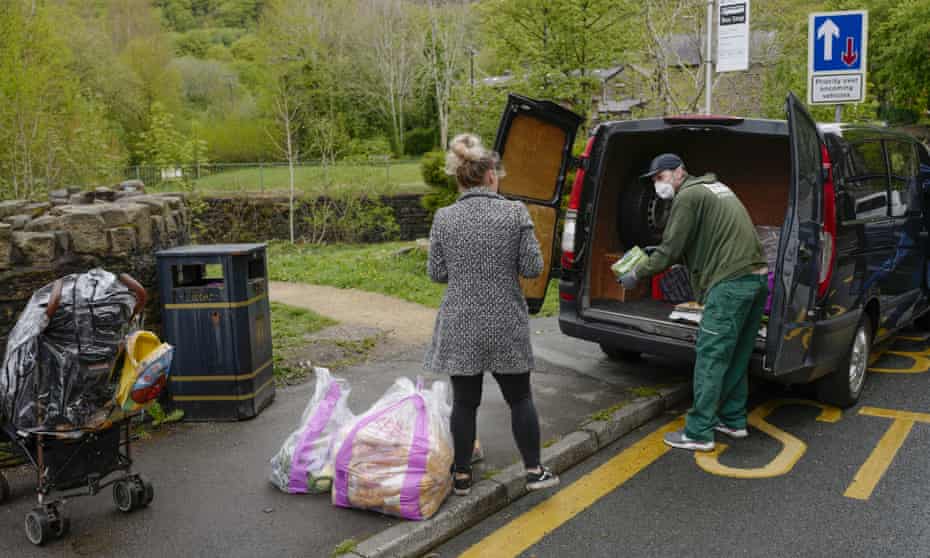 Volunteers help restock a community food bank in Carrbrook Village, Greater Manchester.