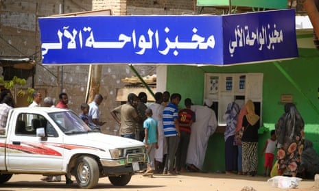 Residents of Khartoum queue in front of a bakery, on 9 April 2020, a day after the Sudanese authorities have announced a rise in the price of bread in the capital.