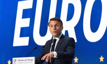 Emmanuel Macron speaking at La Sorbonne with the EU flag behind.