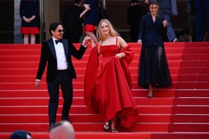 Did Jennifer Lawrence get a last minute red carpet pedi? At the Anatomie D’une Chute premiere, the actress was spotted with a pair of black flip flops underneath her billowing red scarlet Christian Dior couture gown.
