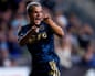 Cavan Sullivan shouts and clenches his fists celebrating a goal in a soccer match