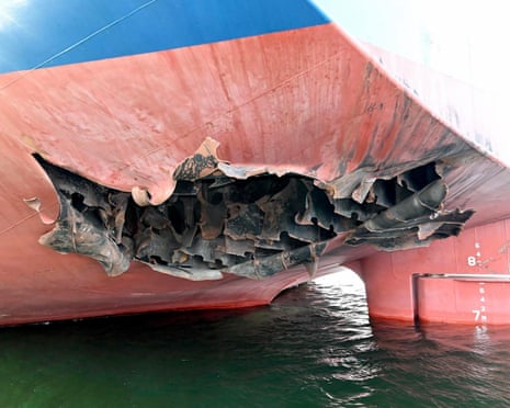 A hole on the side of a ship caused by a suspected missile.