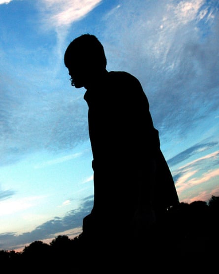 Burial stands silhouetted against a dramatic dark-blue sky