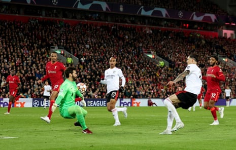Benfica’s Darwin Nunez slots the ball past Liverpool keeper Alisson to score their third goal.