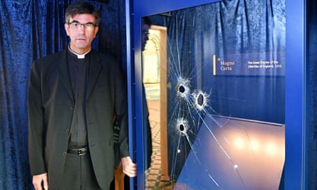 The Rev Canon Nicholas Papadopulos beside the glass case that houses a Magna Carta