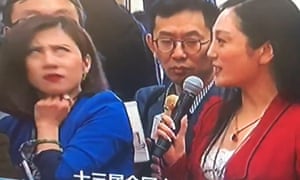 Chinese reporter Liang Xiangyi of Yicai Media, a financial news service, reacts to a softball question asked by another journalist.