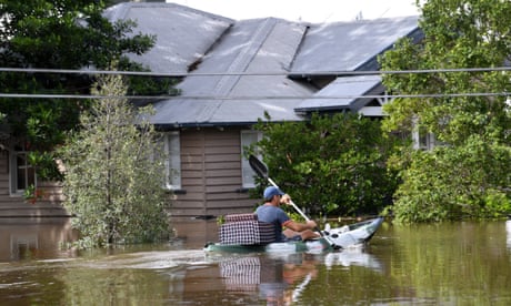 A man is seen paddling a kayak through flood waters covering Torwood Street in the suburb of Milton in Brisbane, Monday, February 28, 2022. 