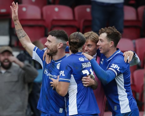 Wigan's Scott Hogan celebrates with teammates after scoring against Reading