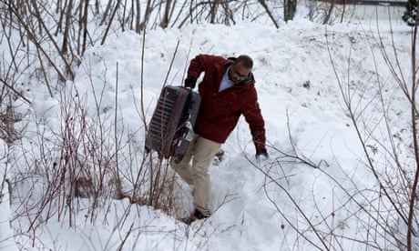 A man from Yemen crosses the U.S.-Canada border into Hemmingford, Quebec, Canada February 14, 2017. REUTERS/Christinne Muschi