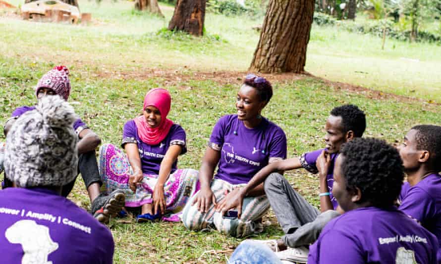 Some young Africans sitting in a park talking