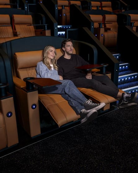 a couple kick back and relax in a cinema reclining seat