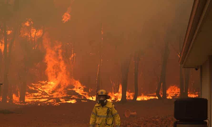A firefighter attends a fire near Wooroloo, northeast of Perth, Australia