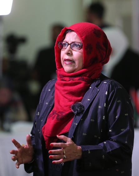 She wears red hijab and spectacles