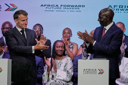 Emmanuel Macron of France and Kenya’s William Ruto applaud each other