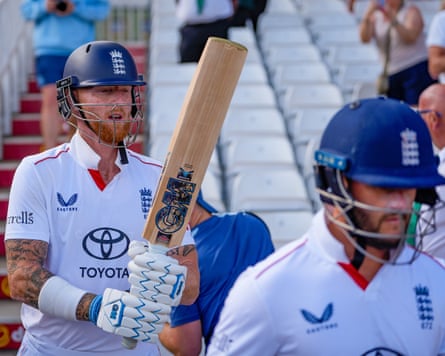 The England cricketers Ben Duckett and Ben Stokes walk out to opening the batting in the last innings of their third Test against New Zealand at Trent Bridge.