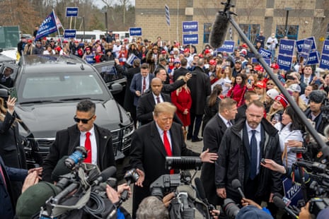 Republican presidential candidate and former President Donald Trump speaks to members of the press outside of Londonderry High School in Londonderry, New Hampshire.