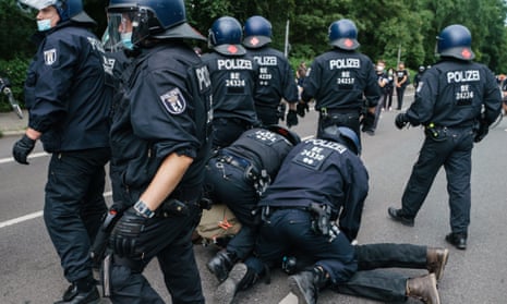 German police officers arrest a protester during a demonstration against Covid-19 restrictions in Berlin.