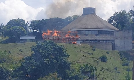 Smoke and flames appear from the Parliament compound in of Honiara, Solomon Islands