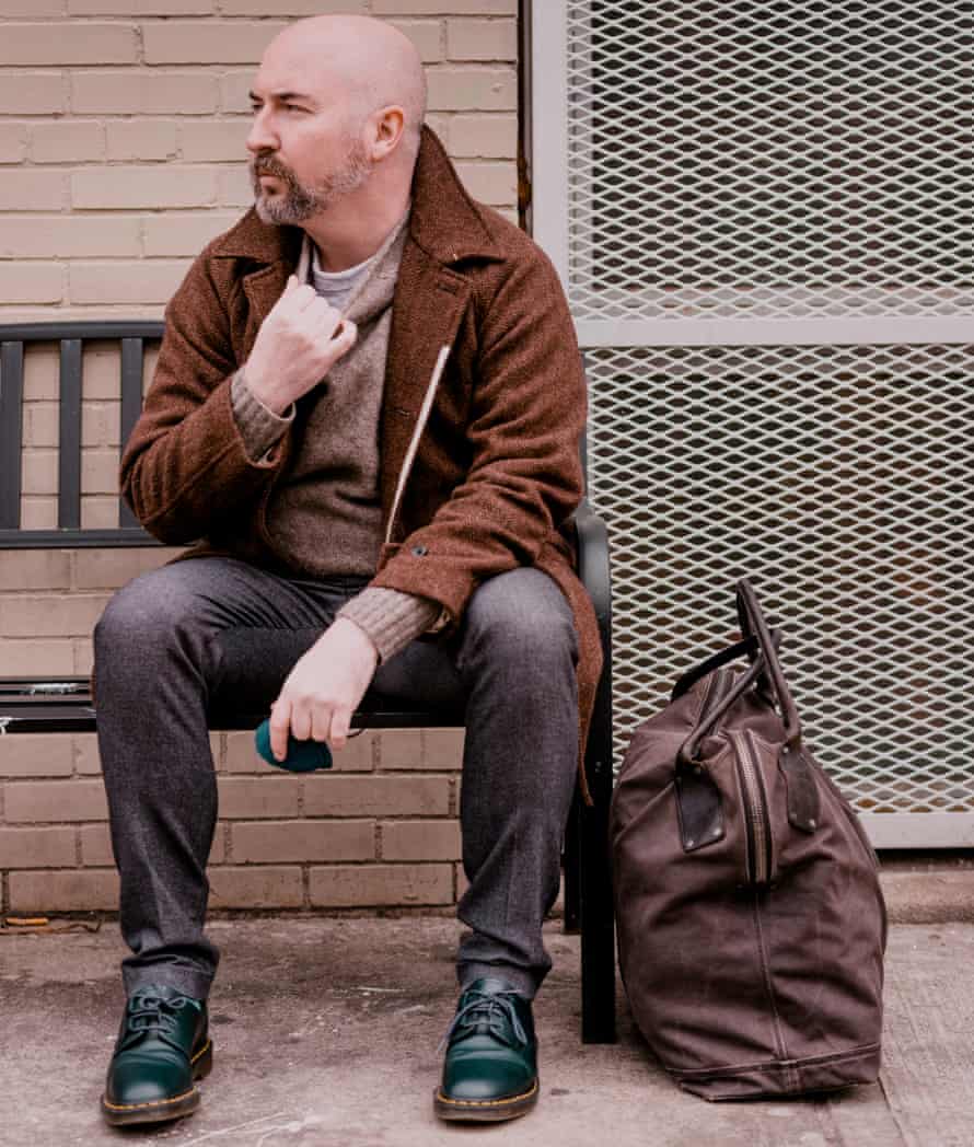Novelist Douglas Stuart sitting on a bench in New York