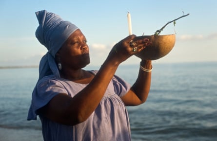 A priestess performs a ritual at a morning at Bord de Mer de Limonade, Haiti.