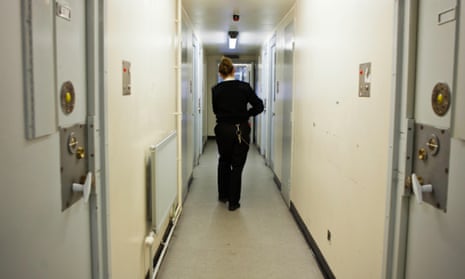 A female prison officer in a residential wing of HM Prison Send, in Surrey.
