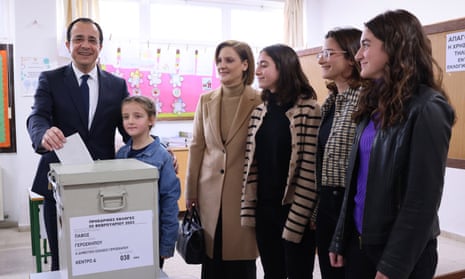 Nikos Christodoulides, flanked by his family, casts his ballot