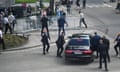Security officers move Slovak PM Robert Fico in a car after a shooting incident,