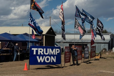 Signs and flags supporting Trump are seen during a trucker convoy rally against people crossing the US-Mexico border on 3 February in Quemado, Texas.