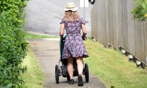 woman pushes a baby in a stroller