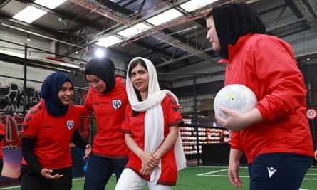Malala Yousafzai standing with players from the Afghanistan women’s team.