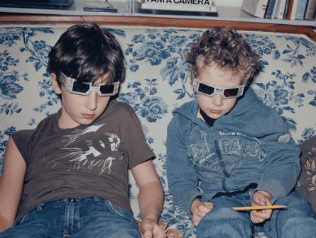 Two boys on a sofa with 3D glasses