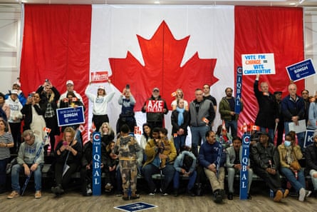 People in front of Canadian flag