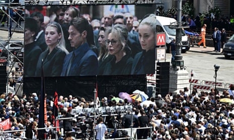 A giant screen showing a live broadcast of  Silvio Berlusconi's family inside the Duomo cathedral in Milan for the state funeral of Italy’s former prime minister