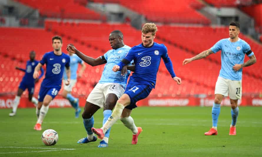 Chelsea’s Timo Werner (right) holds off Manchester City’s Benjamin Mendy to shoot.