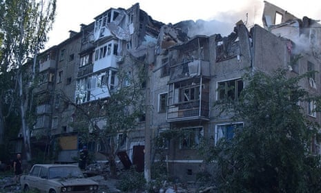A rescuer stands next to a residential building in Mykolaiv, Ukraine.