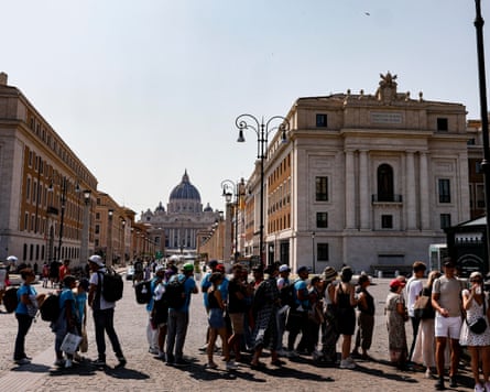 People queue for water at a public fountain near St Peter’s Square in Rome.