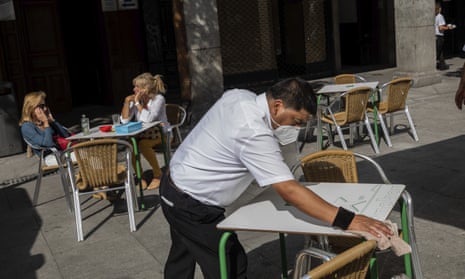A waiter disinfects a table in central Madrid on Wednesday. 
