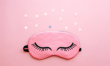 Pink sleep mask over pink background.