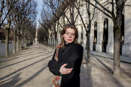 A young woman in a classic formal Parisian public garden