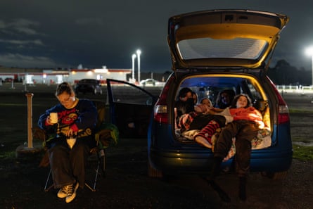 Keziah Gillam sets up a camp chair, while her 13-year-old daughter and friends watch a thriller/horror movie.