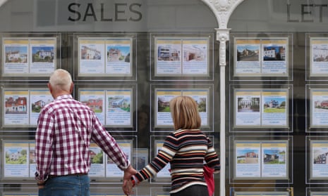 Couple looking in estate agent window in Lewes