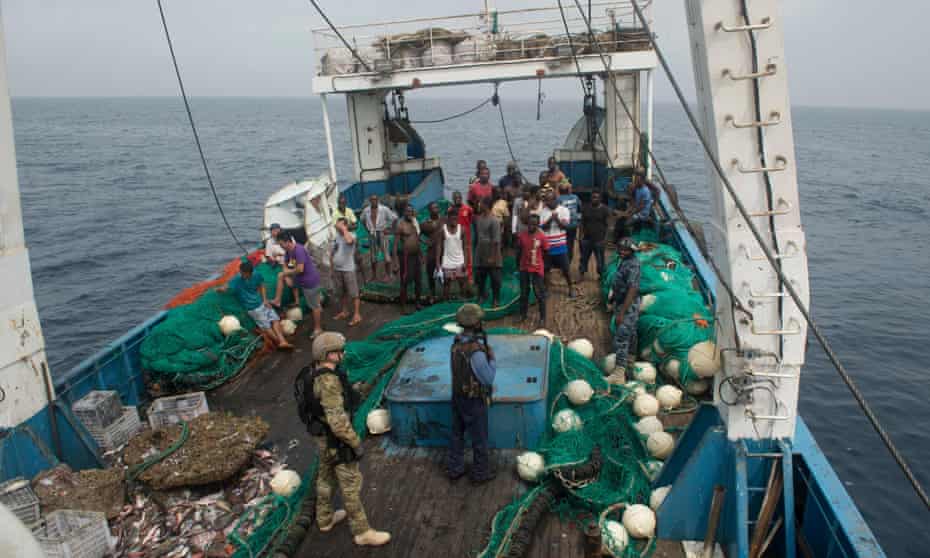 Ghanaian navy and US coast guard officers board a fishing vessel in the Atlantic in 2016.
