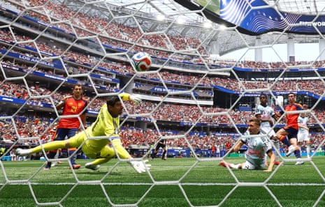 Spain's Fabian Ruiz scores their first goal past Belgium's keeper Thibaut Courtois.
