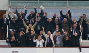 Chelsea manager Jose Mourinho stands dejectedly at the back as West Ham co-chairman David Sullivan and fans celebrate their second goal.