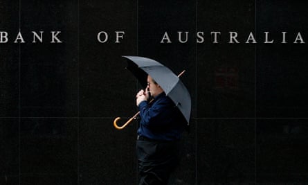 A man walks past the Reserve Bank of Australia building in central Sydney