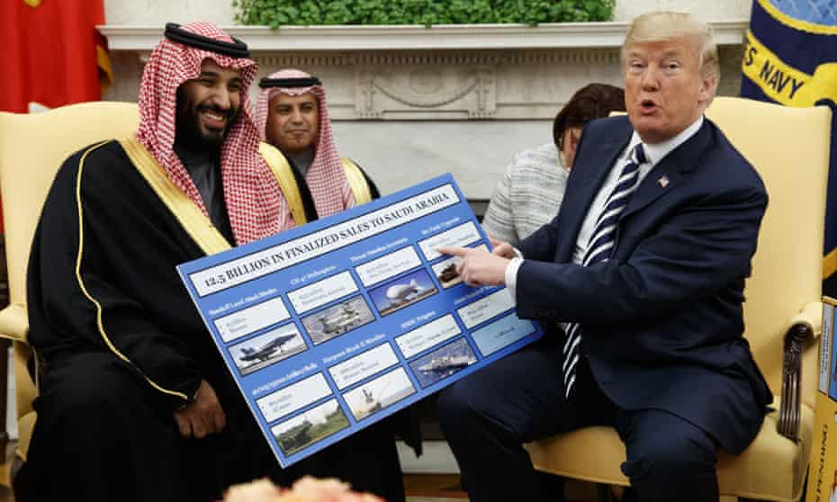 Donald Trump holds a chart highlighting arms sales to Saudi Arabia